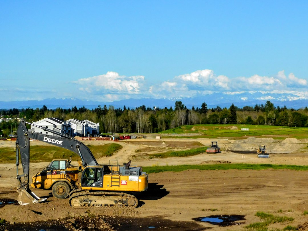 Excavator grading a rural building lot before construction begins