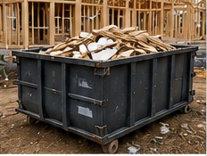 Construction dumpster filled with debris at a framed house job site