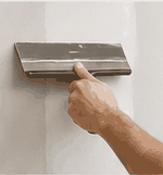 Third finish coat applied with wide drywall knife