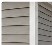 Close-up of neutral vinyl siding and basic trim.