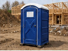 Blue portable restroom at a residential construction site