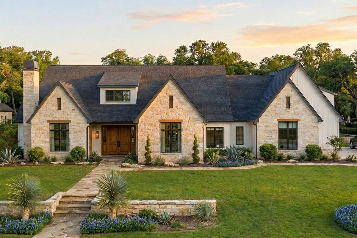 Exterior rendering of Plan 623216DJ, a single-level Transitional European home with a stone and board-and-batten facade, steep gable rooflines with dormers, and an attached side-entry three-car garage
