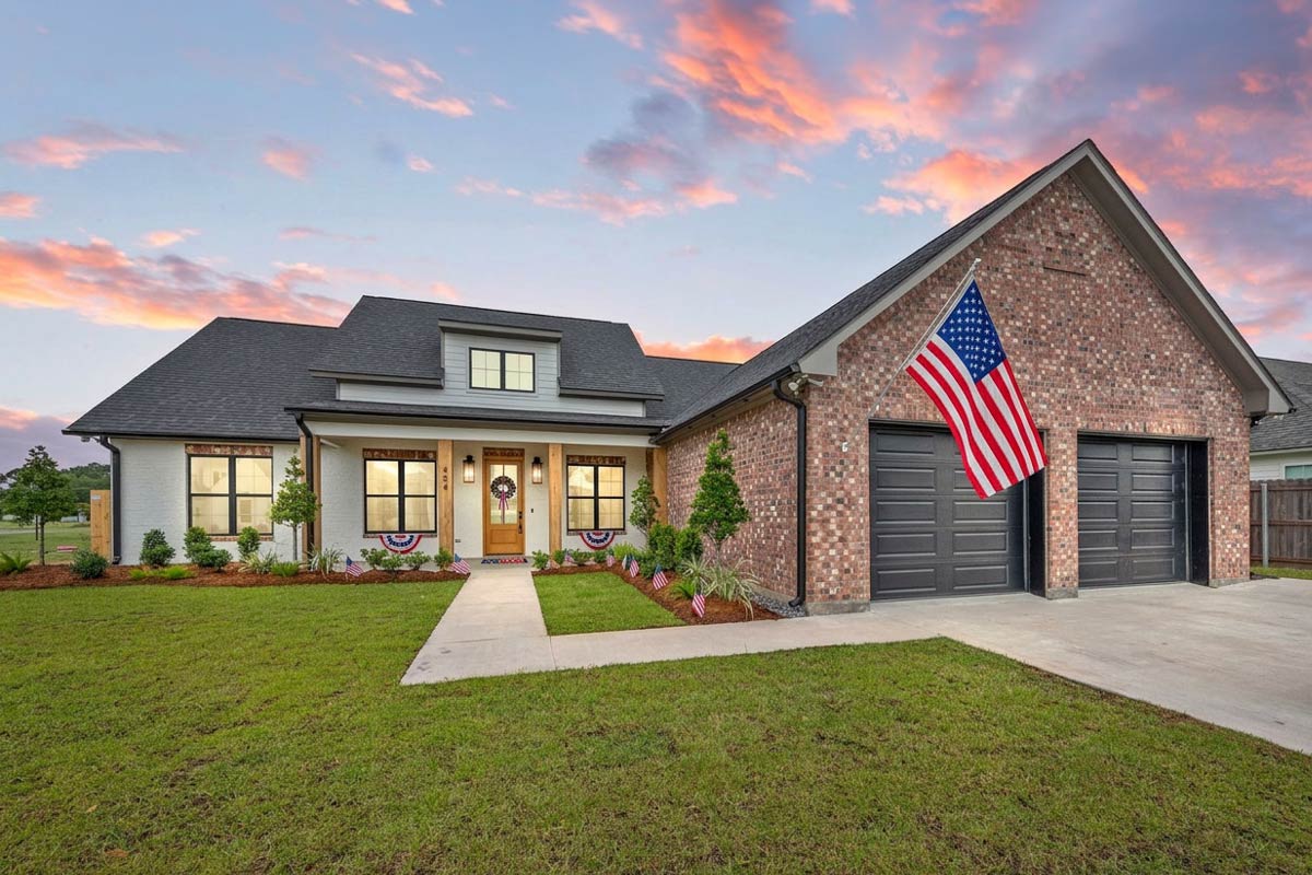 Exterior rendering of Plan 185047PHD, a single-story Modern Farmhouse with a covered front entry, board-and-batten and stone accents, a steep gabled roofline, and a front-entry 2-car garage