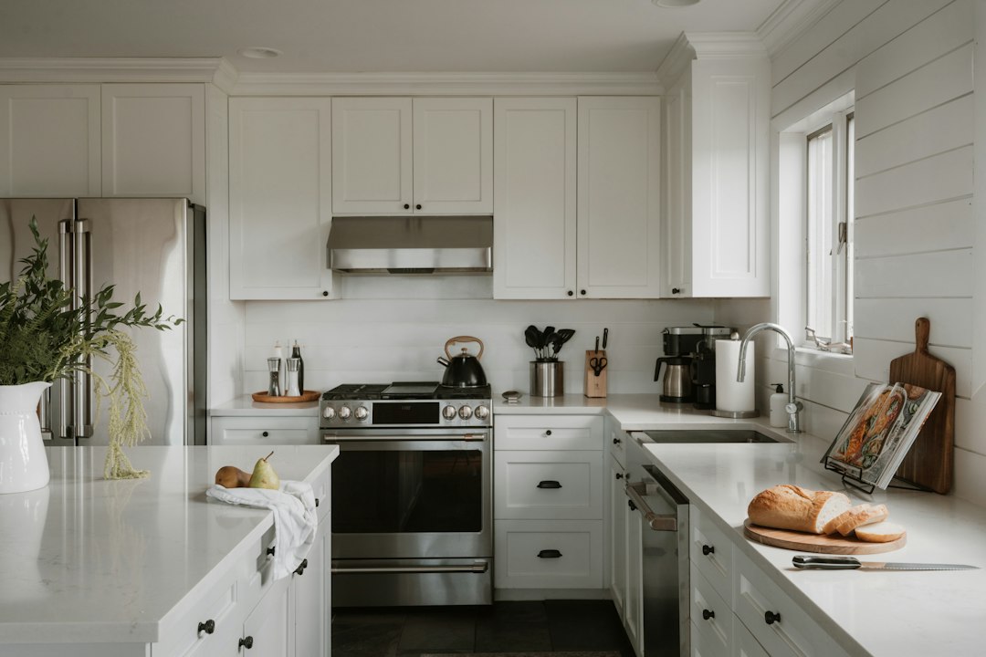 White farmhouse kitchen with shaker cabinets, shiplap and a large island