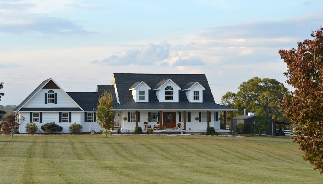 White farmhouse with dormers and a full-width covered front porch